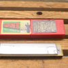 Vintage Hohner harmonica with elegant packaging, perfect for music lovers and collectors.