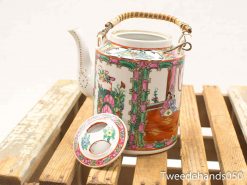 Vibrant hexagonal hand-painted teapot, displaying intricate designs and cultural artistry, perfect for decoration.