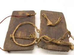 Vintage wooden artifact with rope binding, showcasing craftsmanship and signs of historical use.