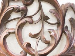 Elegant wooden carving with floral motifs showcasing exquisite craftsmanship and timeless beauty.