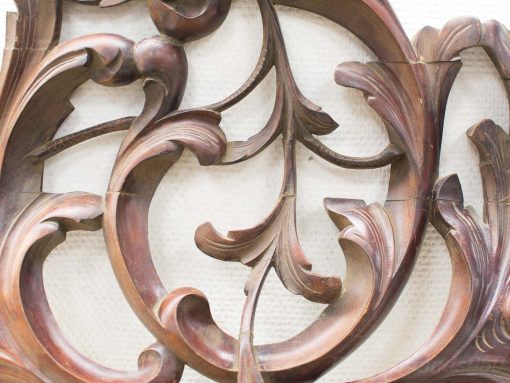 Elegant wooden carving with floral motifs showcasing exquisite craftsmanship and timeless beauty.