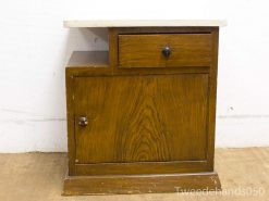 Vintage wooden cabinet with contrasting countertop, perfect for storage and home decor.