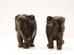 Handcrafted wooden elephant figurines symbolize friendship and luck, adding warmth to any decor.