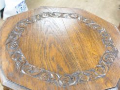 Elegant wooden table with intricate carvings and polished finish, perfect for any decor.