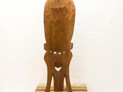 Artistic wooden sculpture in African style with intricate details and warm tones.