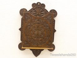 Intricate handcrafted wooden wall shelf with ornate carvings and rich dark finish.