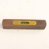 Vintage wooden spirit level with brass vial, showcasing craftsmanship and accuracy for construction projects.