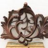 Intricate floral wooden ornament, showcasing craftsmanship and elegance for decorative accents in any interior.