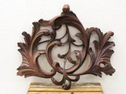 Intricate floral wooden ornament, showcasing craftsmanship and elegance for decorative accents in any interior.