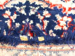 Vintage woven wool tablecloth with rich blue and red patterns and charming fringe details.