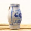 Elegant hand-painted ceramic jug with blue designs, perfect for decoration or kitchen use.