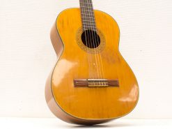 Elegant classical acoustic guitar showcasing a warm wood finish and intricate craftsmanship details.