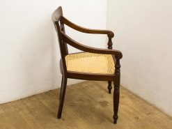 Elegant vintage wooden chair with cane webbing, showcasing timeless design and comfort.