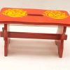 Vibrant red wooden stool with elegant yellow roses, perfect for home decor and functionality.