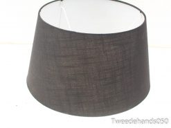 Elegant charcoal drum lampshade with textured fabric and white interior for warm ambiance.