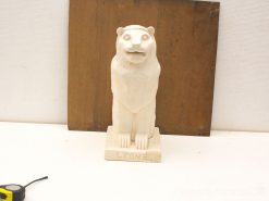 Majestic lion statue with a friendly expression, ideal for collectors and art enthusiasts.