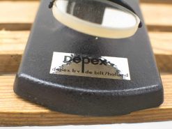 Vintage Depex magnifying glass on rustic wooden surface, ideal for detailed observation and exploration.