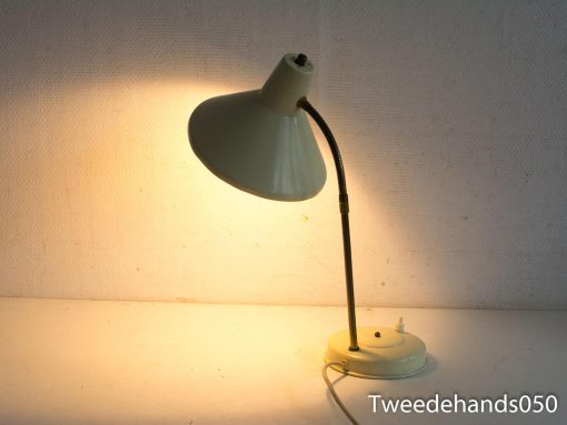 Sleek, minimal desk lamp with flexible neck and warm, diffused light for cozy spaces.