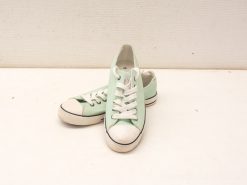 Stylish mint green sneakers with white laces for a casual retro vibe.