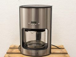 Sleek stainless steel coffee maker with digital display and elegant glass carafe for effortless brewing.