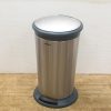 Stylish stainless steel trash can with foot pedal, perfect for modern kitchens and offices.