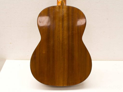 Elegant used acoustic guitar with rich wood grain and glossy finish, showcasing expert craftsmanship.