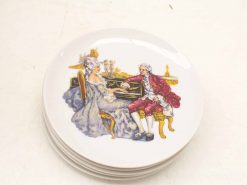 18th-century porcelain plate featuring an elegant couple sharing music at a luxurious piano.