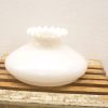 Elegant white glass vase with scalloped edge, perfect for vintage decor and centerpiece displays.