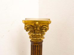 Ornate vintage column with gilded capital, showcasing exquisite craftsmanship and timeless elegance.