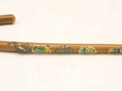 Ornate wooden walking stick showcasing craftsmanship, travel stories, and decorative elements.