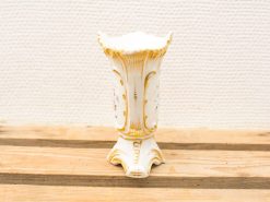 Elegant white ceramic vase with gold accents and floral motifs, perfect for any decor.