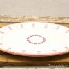 Elegant oval platter with pink floral design for versatile dining occasions.