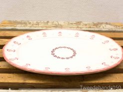 Elegant oval platter with pink floral design for versatile dining occasions.