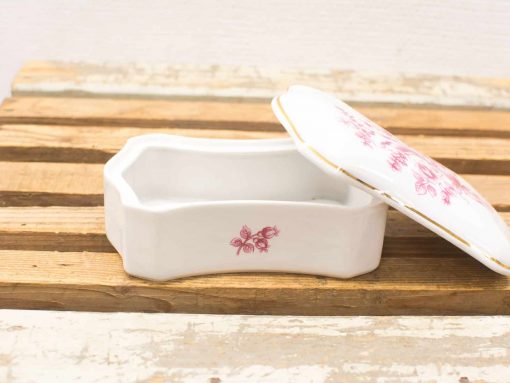 Elegant octagonal porcelain box with pink floral design and gold trim for storing treasures.