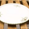 Elegant porcelain plate with floral motifs, perfect for dining and display.