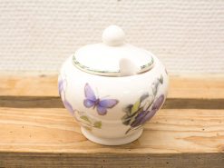 Elegant porcelain sugar bowl with butterfly and floral design, perfect for charming table settings.