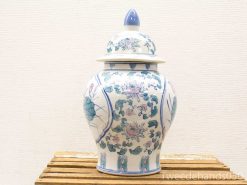 Elegant porcelain urn with lid, featuring delicate lotus flower designs in soft hues.