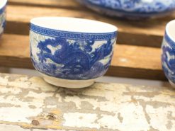 Elegant blue dragon porcelain bowl with intricate designs and a smooth white interior.