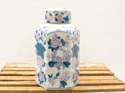 Elegant hexagonal porcelain jar with intricate floral designs in pink and blue tones.