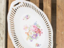 Elegant oval porcelain platter with floral design, perfect for serving and decor.