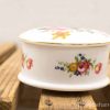 Elegant porcelain trinket box with vibrant floral design, perfect for decor or storing keepsakes.