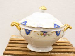 Elegant porcelain tureen with blue and gold accents, perfect for formal dining.