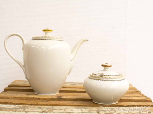 Elegant vintage porcelain teapot and sugar bowl set with gold accents. Perfect for tea service.