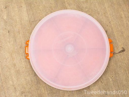 Round storage container with clear lid and orange handles for organizing small items.