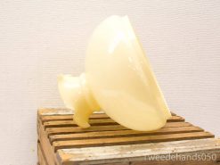 Elegant creamy yellow vintage bowl on rustic wooden base, perfect for decor or functional use.