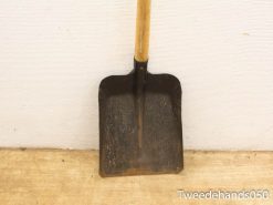 Rustic wooden shovel with a rusty blade, perfect for gardening and outdoor work.