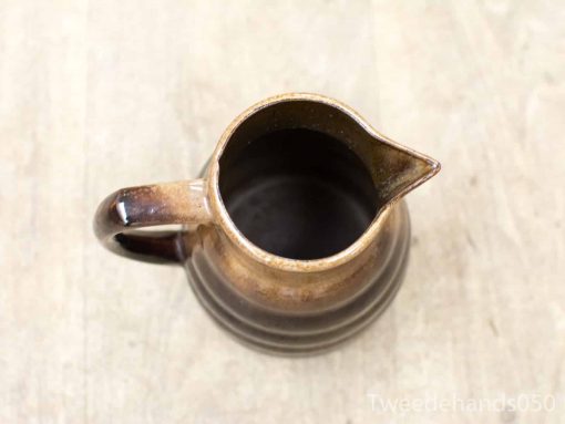 Handmade ceramic pitcher with rustic charm and elegant design, perfect for decor or everyday use.