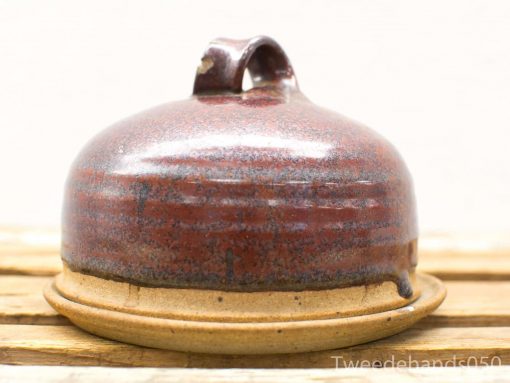 Handmade ceramic cloche with rich reddish-brown glaze, perfect for serving and decoration.