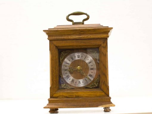 Vintage wooden table clock with Roman numerals and elegant gold accents, perfect for any decor.