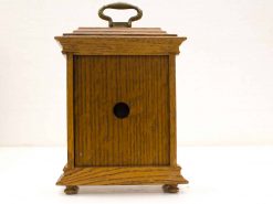 Vintage oak storage box with brass handle, perfect for organizing small items.